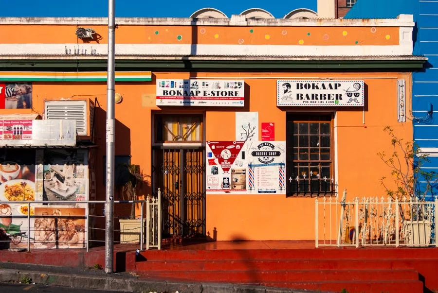 A brightly painted corner store and barber shop in Bo-Kaap, Cape Town